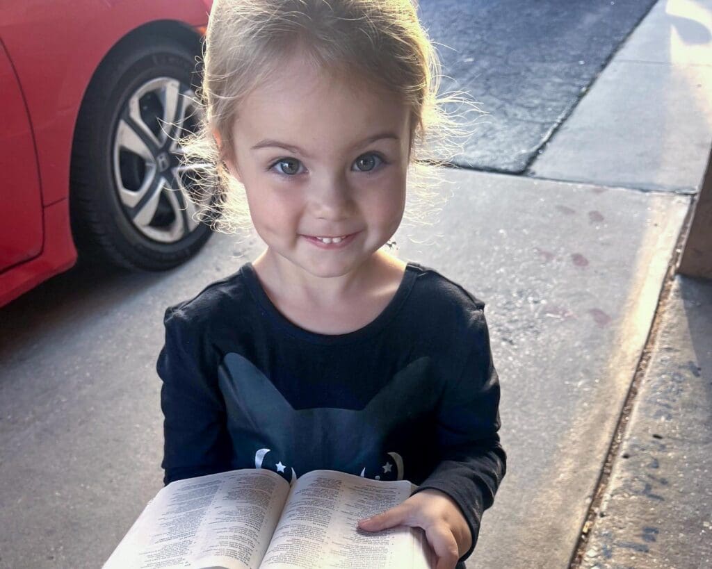 Preschool Student Holding A Bible